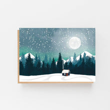 Load image into Gallery viewer, A landscape art print or greeting card featuring a snowy night scene with a small cabin, pine trees, mountains, and a full moon, shown against a clean white background.