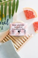 Load image into Gallery viewer, Rose Lavender Grapefruit conditioner bar with grapefruit slices and a plant on a white background