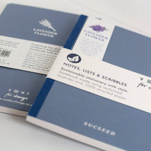 Load image into Gallery viewer, Two blue notebooks with labels on a light gray background