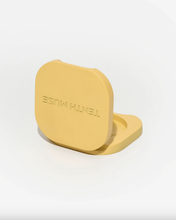 Load image into Gallery viewer, Yellow compact with 'TENTH MUSE' branding on a white background
