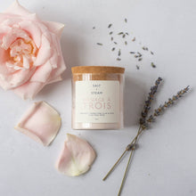 Load image into Gallery viewer, A glass jar with a cork lid labeled 'Salt & Steam' containing a dry face mask powder, alongside a pink rose and lavender sprigs on a white background.
