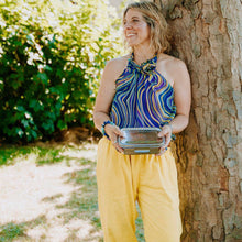 Load image into Gallery viewer, Woman holding a metal container outdoors near a tree