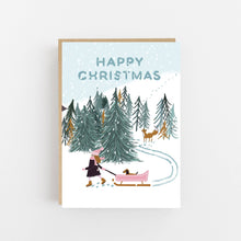 Load image into Gallery viewer, Christmas card with a winter scene, trees, and people with a sled.