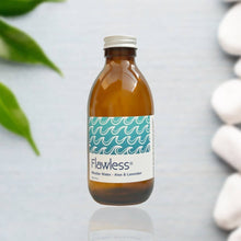Load image into Gallery viewer, Brown bottle with 'Flawless' label on a light gray background with green leaves and white stones.