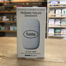 Load image into Gallery viewer, Fussy refillable natural deodorant packaging on a wooden surface with a blurred store background