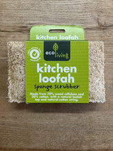 Load image into Gallery viewer, A packaged kitchen loofah sponge scrubber on a wooden surface. The product has a green cardboard header card with the brand 'eco living' and the text 'kitchen loofah sponge scrubber,' with the natural beige loofah material visible on both sides.