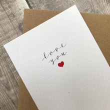 Load image into Gallery viewer, White card with 'love you' text and red heart on a wooden surface