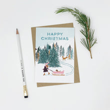 Load image into Gallery viewer, Christmas card with winter scene illustration, pencil, and pine branch on white background