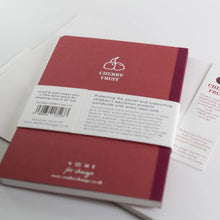 Load image into Gallery viewer, Red notebook with Cherry Fruit branding on a white background