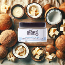 Load image into Gallery viewer, Jar of 'The Natural Deodorant Co.' coconut + shea gentle deodorant cream surrounded by coconuts and coconut pieces on a wooden surface.