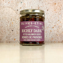 Load image into Gallery viewer, Jar of olives with a purple label on a textured surface