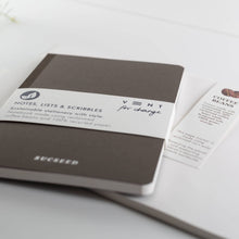 Load image into Gallery viewer, Brown notebook with a label on a white surface
