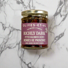 Load image into Gallery viewer, Jar of olives with a purple label on a marble background
