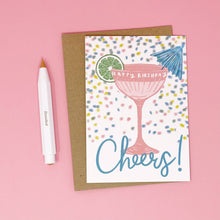 Load image into Gallery viewer, Birthday card with cocktail illustration and 'Cheers!' text on a pink background
