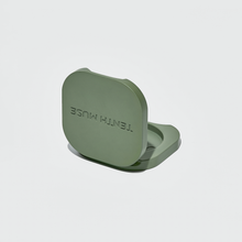Load image into Gallery viewer, Green perfume vessel with 'TENTH MUSE' branding on a light gray background

