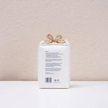 Load image into Gallery viewer, White product packaging with a gold bow on a beige background
