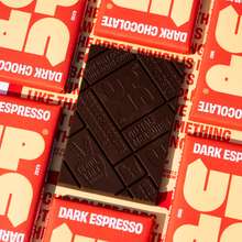 Load image into Gallery viewer, Dark chocolate bar on top of red and white U.P. Dark Chocolate packaging
