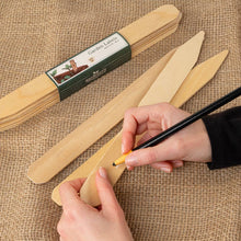 Load image into Gallery viewer, Wooden garden labels with a hand using a marker on a burlap background
