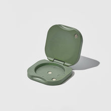 Load image into Gallery viewer, Green folding perfume vessel on a light gray background
