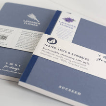 Load image into Gallery viewer, Two blue notebooks with labels on a light gray background
