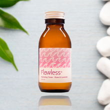 Load image into Gallery viewer, Brown bottle with pink label featuring 'Flawless' on a light gray background with green leaves and white stones.
