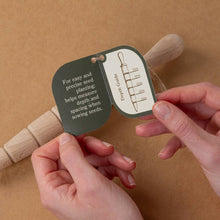 Load image into Gallery viewer, Hand holding a seed planting tool with measurement guide on a brown background

