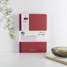 Load image into Gallery viewer, Red notebook with white label on a light background
