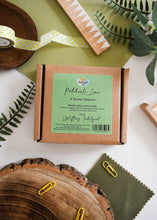 Load image into Gallery viewer, Box of 'Patchouli Lime' shower steamers with a green label on a white surface with decorative elements.
