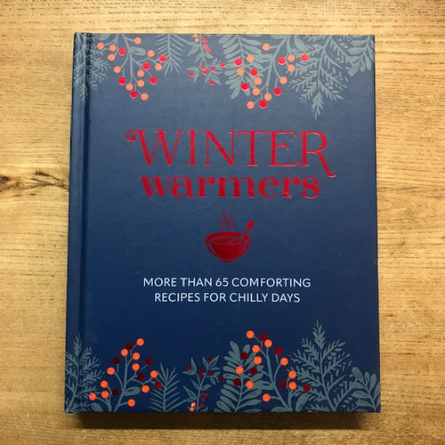 Book titled 'Winter Warmers' with decorative elements on a wooden surface