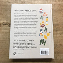 Load image into Gallery viewer, Back cover of a book with illustrations and text on a wooden surface
