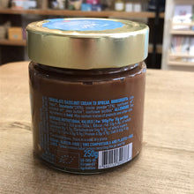 Load image into Gallery viewer, Jar of chocolate hazelnut cream with a gold lid on a wooden surface

