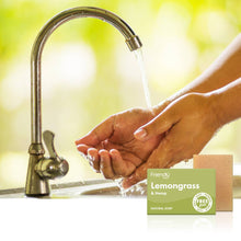 Load image into Gallery viewer, Person washing hands under a faucet with a bar of Friendly Soap Lemongrass &amp; Hemp in the foreground.
