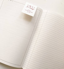 Load image into Gallery viewer, Open notebook with lined pages and a visible brand label on a white background
