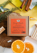 Load image into Gallery viewer, Box of Orange Masala shower steamers with oranges and cinnamon sticks on a yellow background

