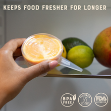 Load image into Gallery viewer, Hand holding a container with a spoon, surrounded by fruits, with text 'Keeps food fresher for longer' and certification logos.
