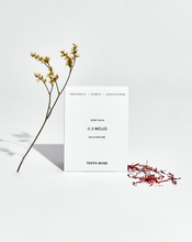 Load image into Gallery viewer, Tenth Muse solid perfume with floral elements on a light background
