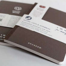 Load image into Gallery viewer, Brown notebooks with 'Succeed' branding on a white surface
